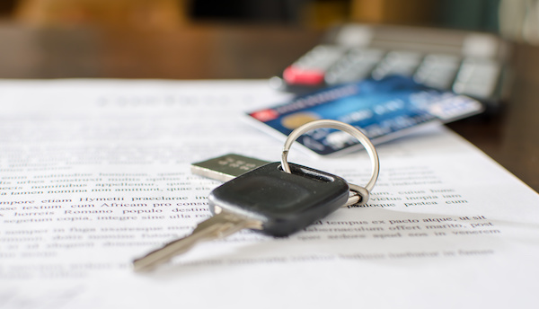 Car key, credit card on a signed sales contract